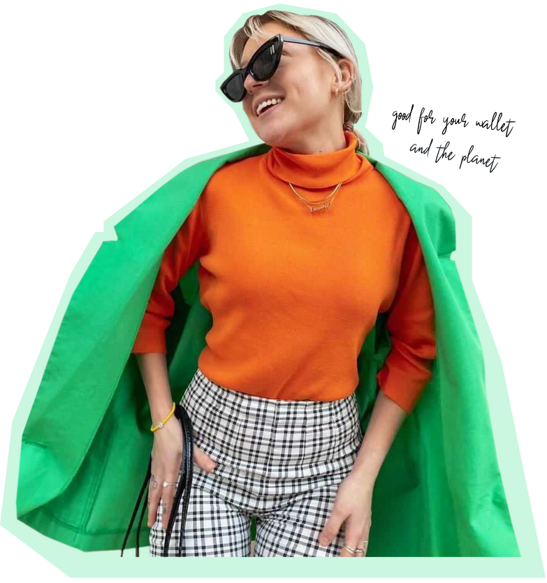 Emily Grace Kelly with plaid pants, orange turtleneck, green trench coat outfit with black handbag & gold necklace & bracelet